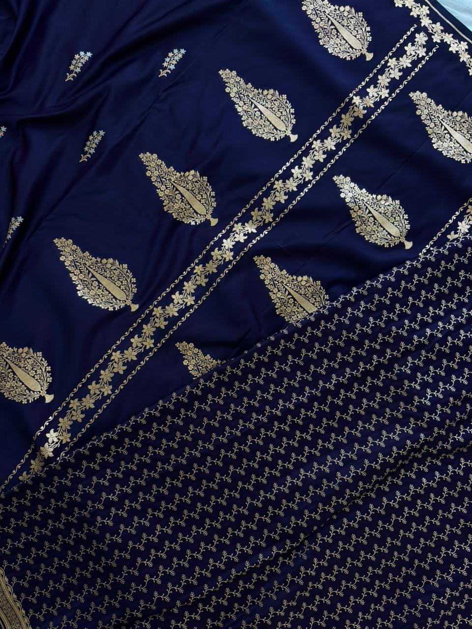 Navy blue Mashru silk saree with intricate gold border from Kalisa Banaras, draped to showcase elegant traditional craftsmanship.